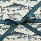 Vintage-style wrapping paper with a fish print and a teal satin ribbon, perfect for a fisherman's birthday gift.