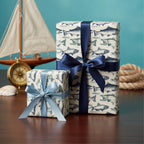 Two gifts wrapped in fish pattern wrapping paper with satin bows for a nautical-themed celebration.