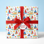 Nautical sailboat wrapping paper with a red bow and Wrapped Studios tag, ideal for kids birthday or baby shower.