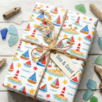 Nautical beach gift wrap with sailboats and lighthouses, tied with rustic twine by Wrapped Studios.