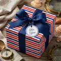 Nautical red, white, and blue striped wrapping paper with a navy bow by Wrapped Studios.