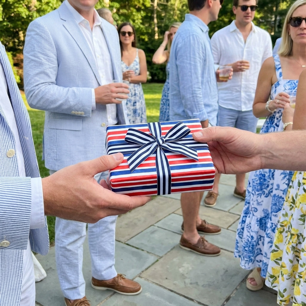 Red, white, and blue patriotic wrapping paper with a nautical bow at a summer party by Wrapped Studios.