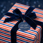 Red, white, and blue striped wrapping paper with a navy velvet ribbon by Wrapped Studios.