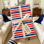 Red white and blue striped patriotic wrapping paper with a cream bow by Wrapped Studios.