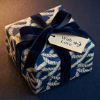 Navy blue nautical wrapping paper with rope pattern and velvet bow by Wrapped Studios.