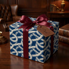 Father's Day gift wrap with blue nautical rope pattern, burgundy ribbon, and leather Dad tag by Wrapped Studios.
