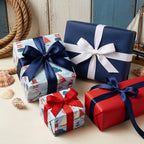 Nautical wrapping paper with sailboat and lighthouse patterns on gifts by Wrapped Studios.