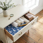 Nautical sailboat wrapping paper lining a vintage dresser drawer by Wrapped Studios.