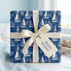 Nautical sailboat wrapping paper with a cream cotton bow and Warm Wishes tag by Wrapped Studios.