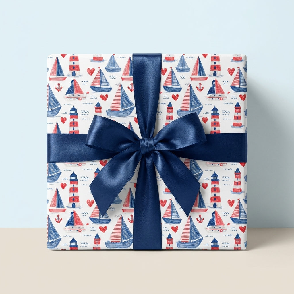 Nautical wrapping paper with sailboats and lighthouses, tied with a navy blue bow by Wrapped Studios.