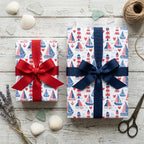 Nautical sailboat wrapping paper with lighthouses and red and blue ribbons by Wrapped Studios.