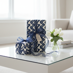 Modern navy blue and white wave pattern gift wrap with sheer navy ribbon, perfect for stylish birthday or luxury presents.