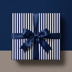 Luxury navy and white striped wrapping paper with a blue satin ribbon bow by Wrapped Studios.