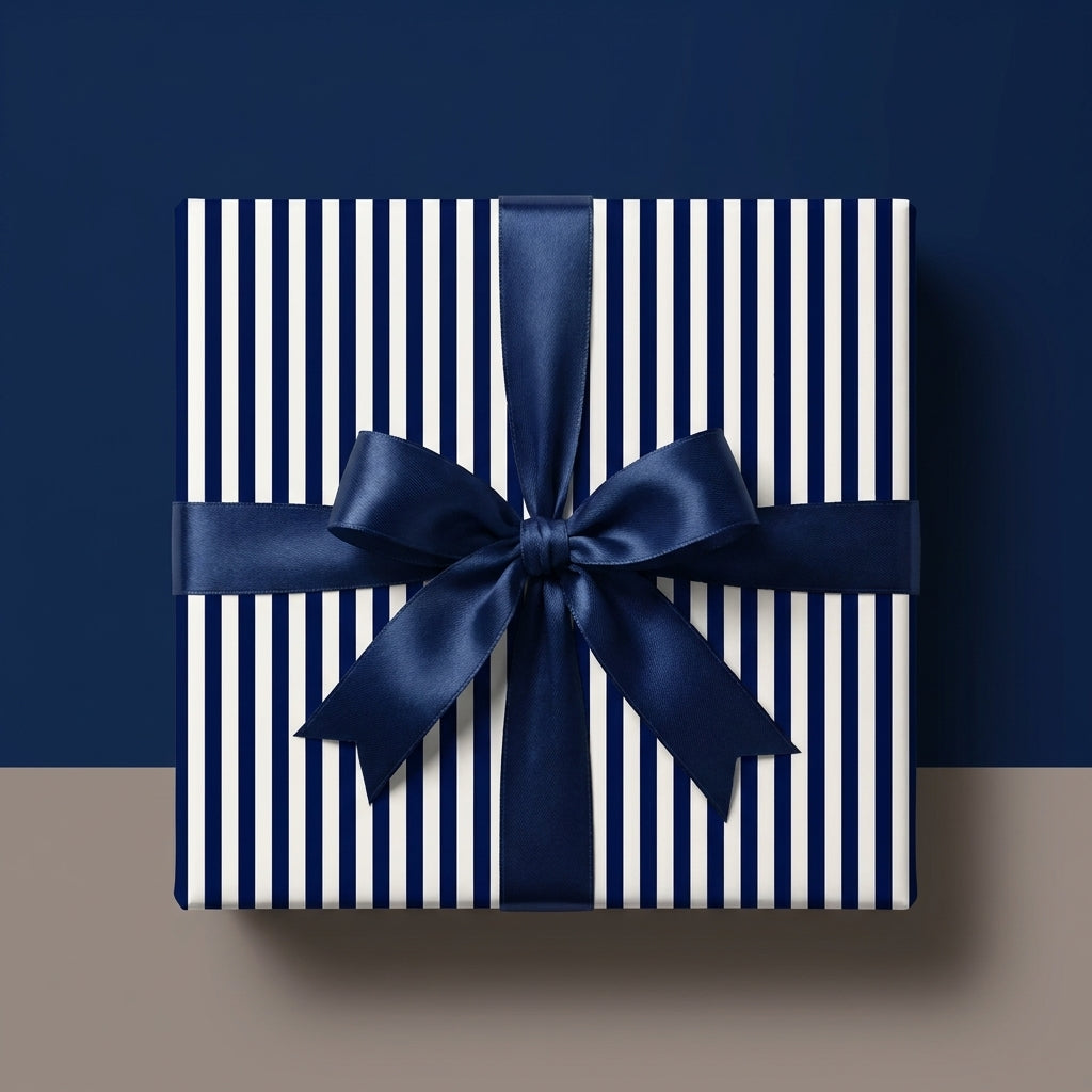 Luxury navy and white striped wrapping paper with a blue satin ribbon bow by Wrapped Studios.