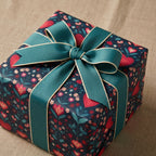 Gift box with floral pattern and teal ribbon on a textured surface