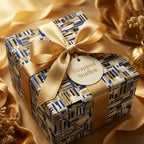 Luxury gift box featuring modern blue and gold geometric wrapping paper with an elegant satin ribbon by Wrapped Studios.
