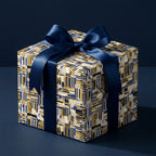 Luxury gift box with modern blue and gold geometric wrapping paper and a sleek navy satin ribbon by Wrapped Studios.