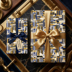 Luxury gift wrap by Wrapped Studios featuring a modern geometric pattern in navy, gold, and cream with silk ribbons.