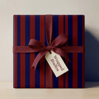 Luxury navy and burgundy striped wrapping paper with maroon ribbon bow by Wrapped Studios.