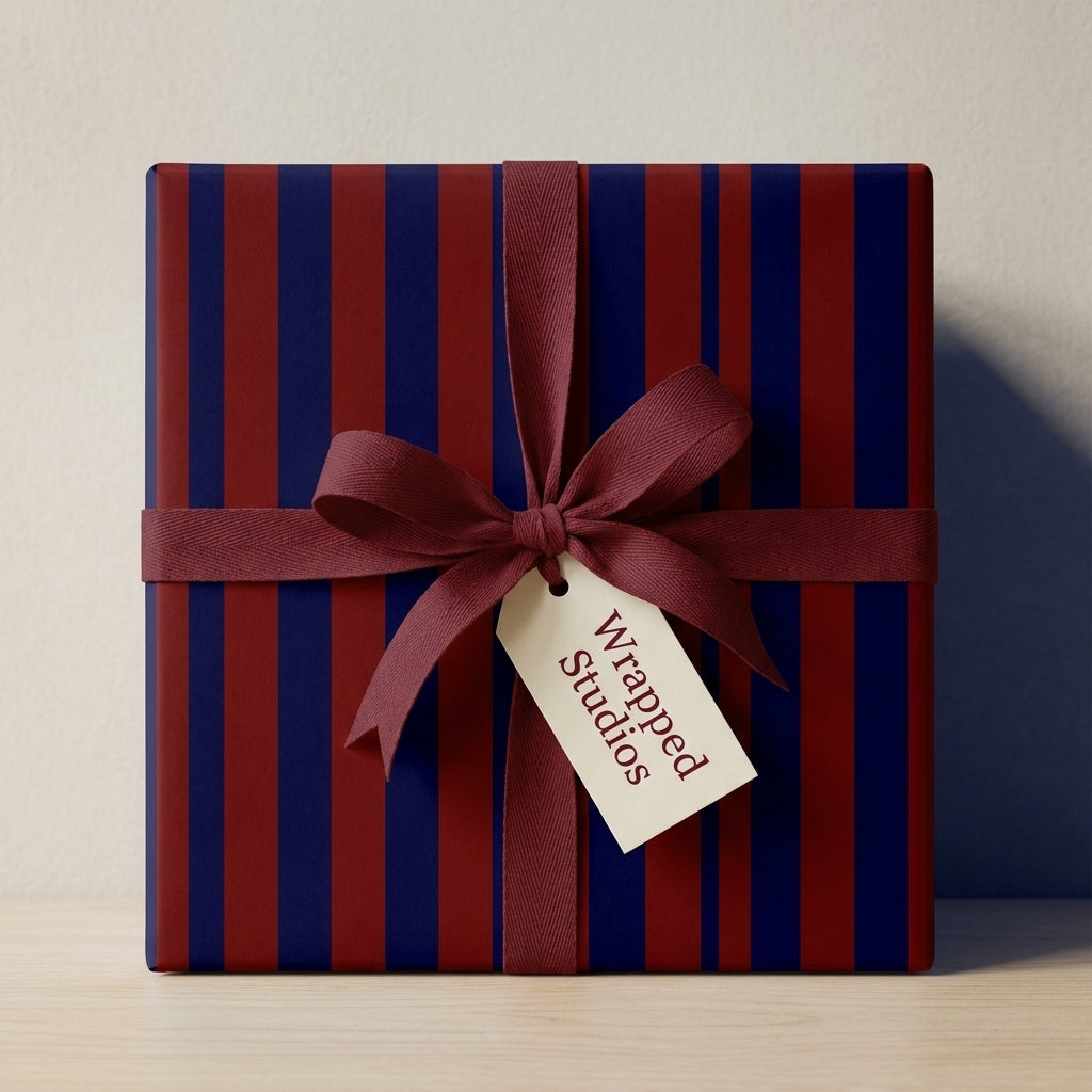 Luxury navy and burgundy striped wrapping paper with maroon ribbon bow by Wrapped Studios.