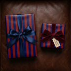 Luxury red and navy striped wrapping paper with elegant satin and velvet bows by Wrapped Studios.