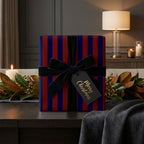 Luxury navy and red striped Christmas wrapping paper with a black velvet bow, by Wrapped Studios.