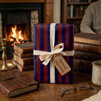 Vintage navy and red striped wrapping paper with a cream ribbon in a cozy study by Wrapped Studios.