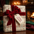 Christmas gift wrapped in nutcracker-themed wrapping paper with a red velvet ribbon and "Merry Christmas" tag.