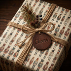 Nutcracker Christmas gift wrapped with brown twine, pine sprigs and a "cheers" tag.
