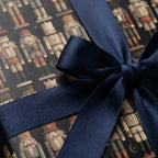 Nutcracker Christmas gift wrap with a luxury navy blue satin ribbon bow by Wrapped Studios.