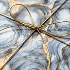 Luxury blue and gold marble wrapping paper tied with a metallic bow by Wrapped Studios.