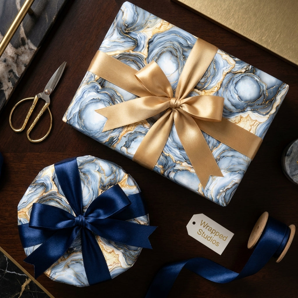 Luxury blue and gold marble gift wrap with elegant satin bows on gift boxes by Wrapped Studios.