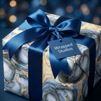 Luxury blue and gold marble wrapping paper with satin bow by Wrapped Studios.