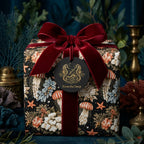 Luxury ocean wrapping paper with vintage jellyfish pattern and red velvet bow by Wrapped Studios.