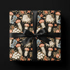 Luxury black coastal wrapping paper with vintage jellyfish pattern and black satin bow by Wrapped Studios.