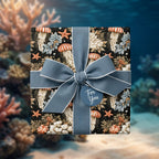 Coastal jellyfish wrapping paper with a blue ribbon on a gift box by Wrapped Studios.