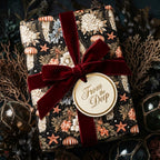 Vintage coastal wrapping paper with jellyfish, starfish, and a burgundy velvet bow by Wrapped Studios.