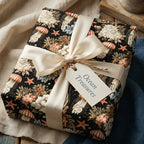 Ocean themed wrapping paper with jellyfish pattern and cream satin bow by Wrapped Studios.