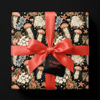 Coastal jellyfish and floral gift wrap with a coral satin bow by Wrapped Studios.