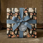 Vintage jellyfish gift wrap with a dusty blue ribbon and "For You" tag by Wrapped Studios.