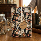 Vintage ocean wrapping paper with jellyfish pattern and twine bow on a gift, by Wrapped Studios.