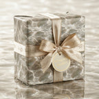 Ocean water print wrapping paper with a luxury cream ribbon and bow by Wrapped Studios.