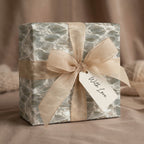 Luxury water ripple wrapping paper by Wrapped Studios on a modern gift box with a champagne ribbon bow.
