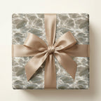 Elegant water ripple luxury gift wrap with a champagne satin bow by Wrapped Studios.
