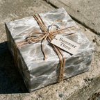 Grey marble wrapping paper with rustic twine and summer gift tag on a gift box by Wrapped Studios.