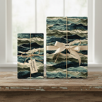 Gifts wrapped in navy wave print wrapping paper with a cream ribbon and twine bow, on a rustic wood surface.