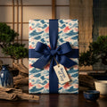 Japanese wave wrapping paper in blue and coral with a navy bow by Wrapped Studios. Elegant luxury gift wrap.