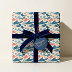 Luxury Japanese wave wrapping paper with a navy velvet ribbon on a square gift box by Wrapped Studios.
