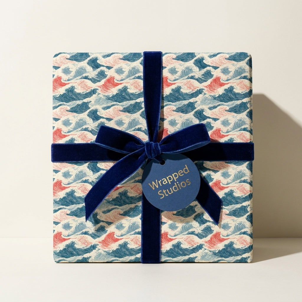 Luxury Japanese wave wrapping paper with a navy velvet ribbon on a square gift box by Wrapped Studios.