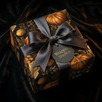 Luxury fall pumpkin wrapping paper with a dark satin bow by Wrapped Studios.
